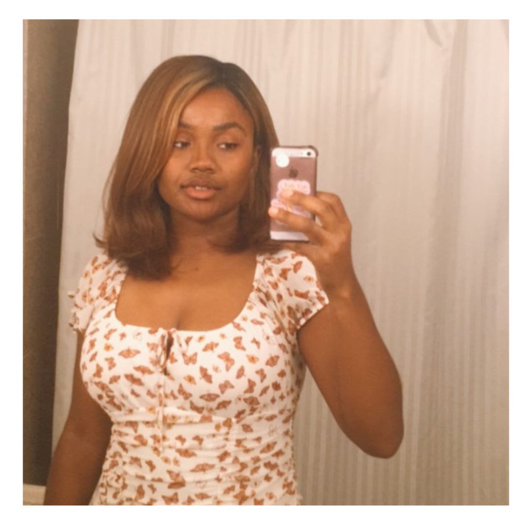 A Black girl (me) taking a selfie in the hotel bathroom