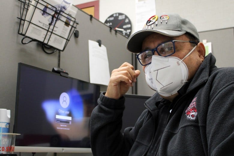 Benjamin Duarte sits in his office wearing an N95 mask, in the O'Connell Technology Center's MESA Engineering Program at Chico State on April 20, 2022. Photo by Julian Mendoza for CalMatters