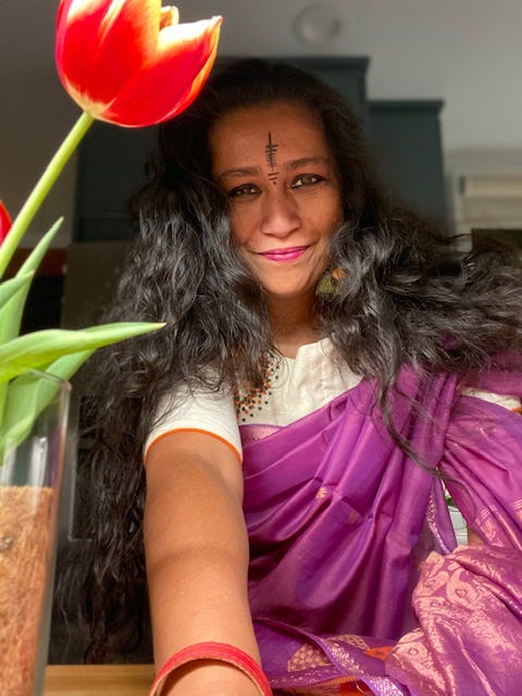 Me in Ma's sari, pretending to be grown up, with a tulip in the foreground (to make it all classy and artsy)