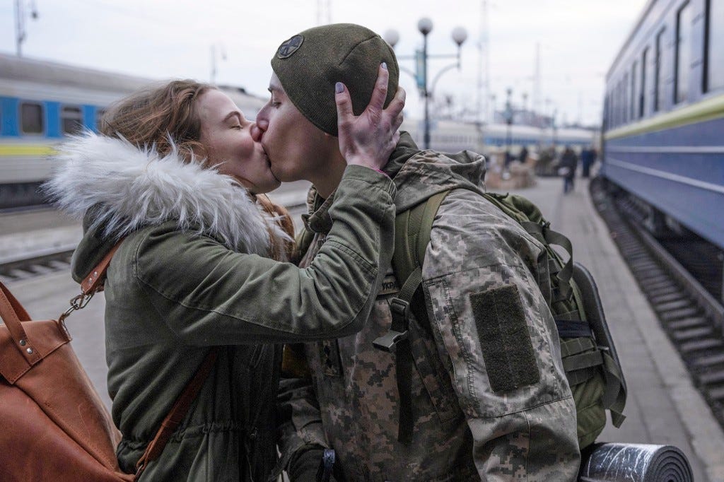 Soldiers say goodbye to their loved ones before boarding a train to Dnipro from the main train terminal on March 09, 2022 in Lviv, Ukraine.