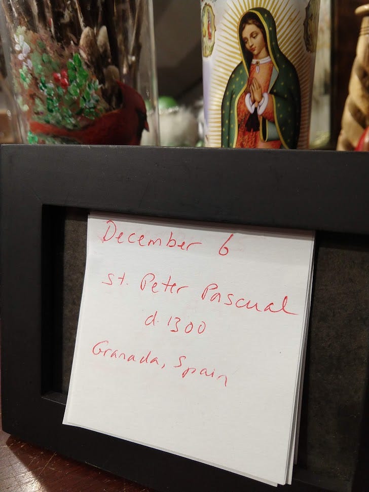 Picture frame with martyr post-its; Guadalupe candle and festive vase rising behind.