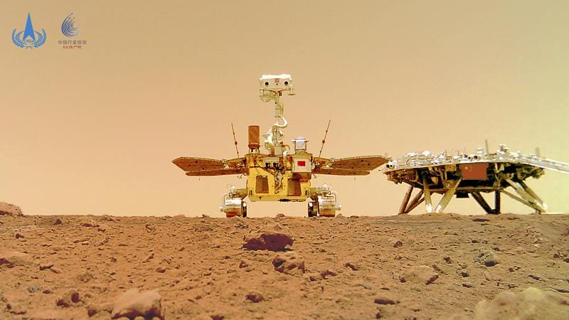 In this image released by the China National Space Administration (CNSA) on Friday, June 11, 2021, the Chinese Mars rover Zhurong is seen near its landing platform taken by a remote camera that was dropped into position by the rover. China on Friday released a series of photos taken by its Zhurong rover on the surface of Mars, including one of the rover itself taken by a remote camera. (CNSA via AP)
