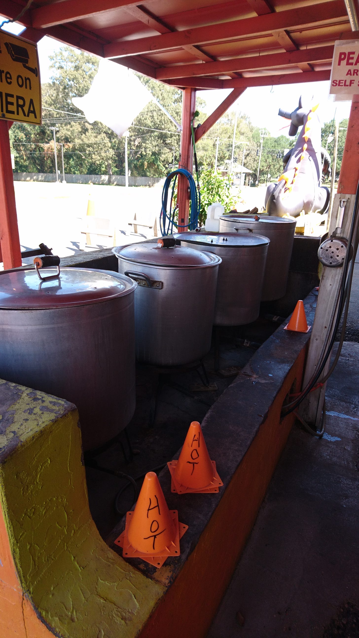 A boiled peanut stall in North Carolina. Four large metals lidded drums contain the peanuts. 