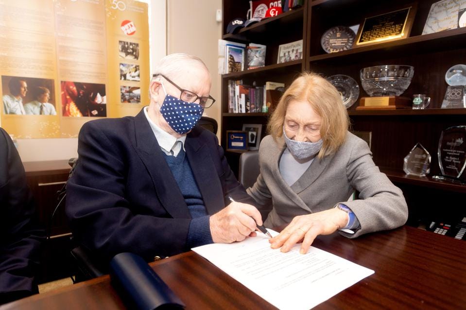 Chuck Feeney signing documents