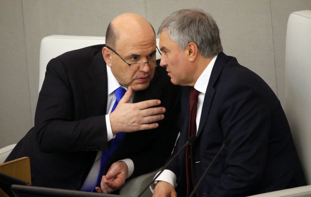 Russian Prime Minister Mikhail Mishustin (L) talks to State Duma Chairman Vyacheslav Volodin (R) during the session of the Duma on April 7, 2022