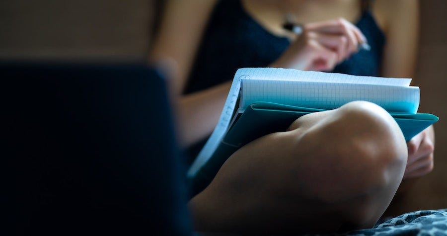 Person writing in a notebook