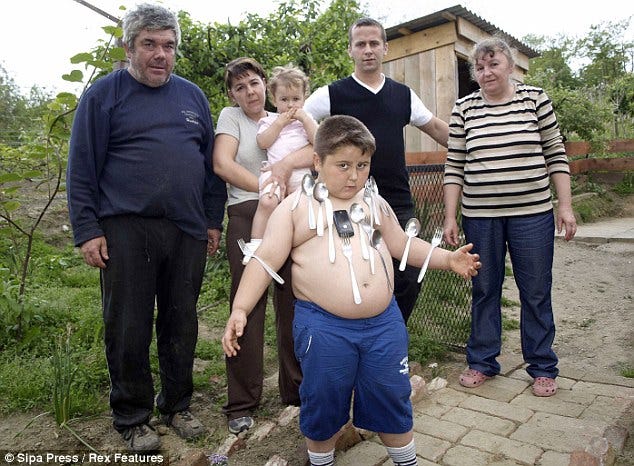 Magnetic personality: Six-year-old Croatian boy Ivan Stoiljkovic is able to stick metal objects to his body, while his family also claim he has extra strength and healing powers