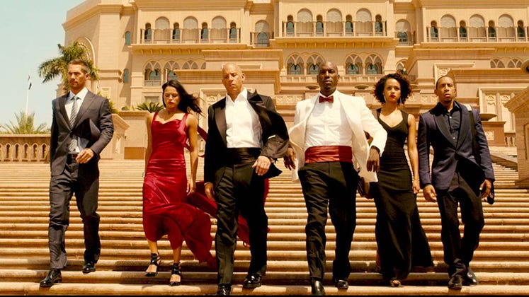 From left, Paul Walker, Michelle Rodriguez, Vin Diesel, Tyrese Gibson, Nathalie Emmanuel and Chris "Ludacris" Bridges star in "Furious Seven," a 2015 Universal Pictures release directed by James Wan.