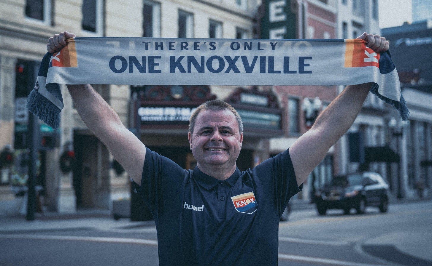 Mark McKeever holds a One Knoxville scarf outside the Tennessee Theatre