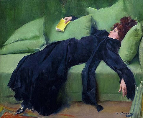 Young woman collapsed on a green couch, exhausted. 