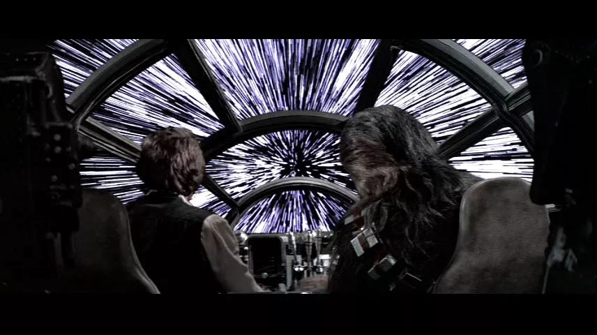 A screengrab from the movie Star Wars where Chewbacca and Han Solo jump into lightspeed.