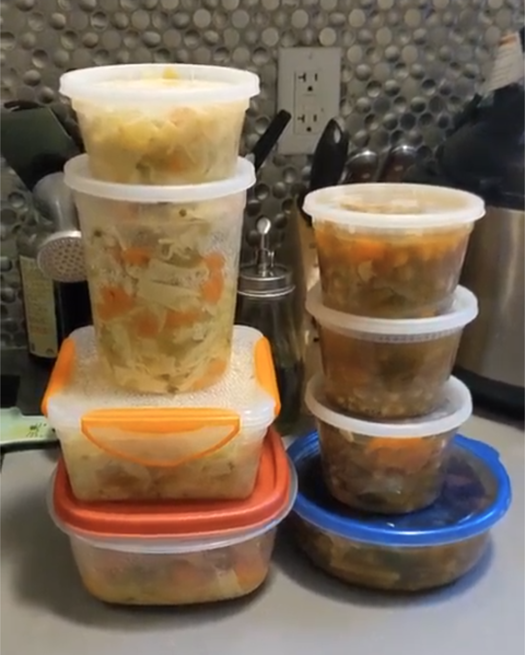 plastic to-go containers of soup stacked