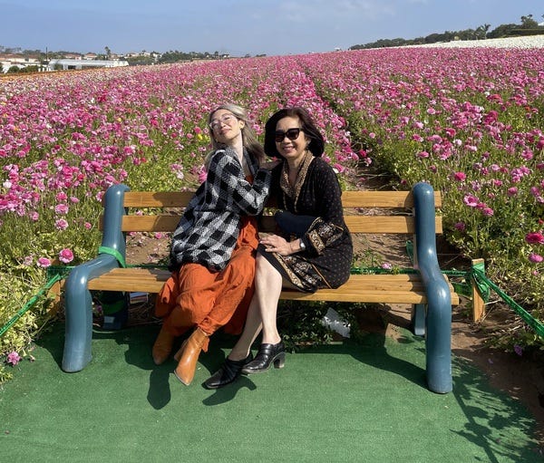 a photo of me and my mother in front of a flower field