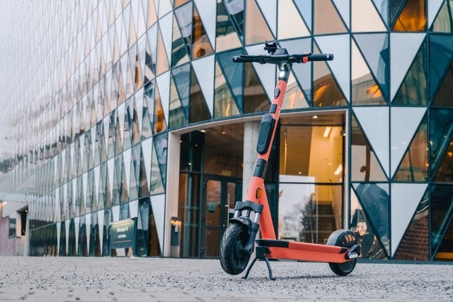 photo of the new V4 e-scooter in front of a building