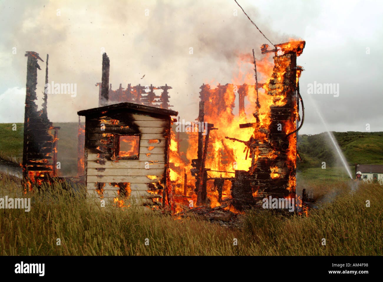 A small house on fire burning to the ground Stock Photo - Alamy