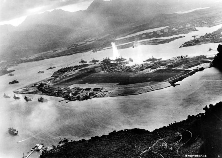A black and white photo of the attack on Pearl Harbor