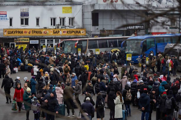 People wait for buses at a bus station as they attempt to evacuate the city on February 24, 2022 in Kyiv, Ukraine. Overnight, Russia began a...