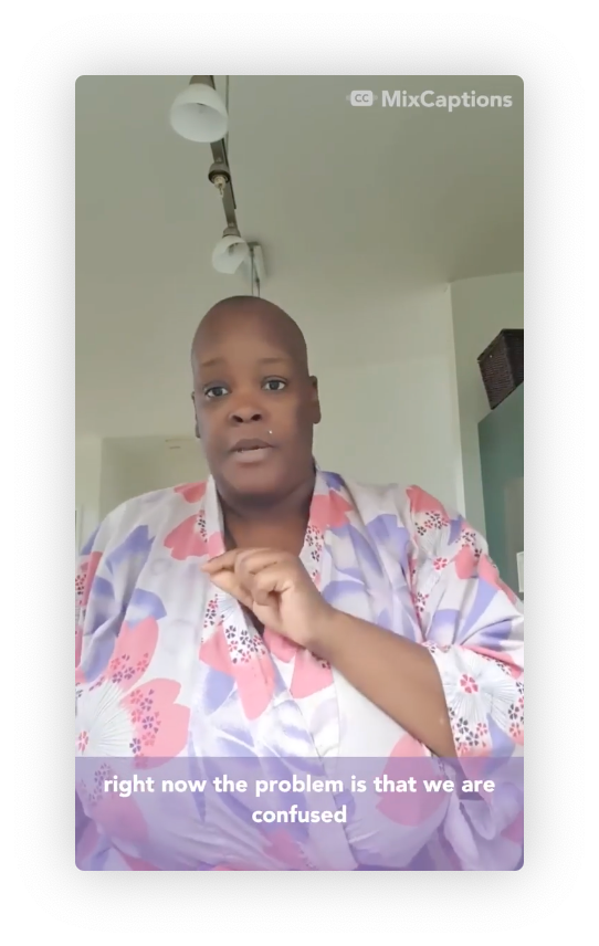 Screen capture of an Instagram video that shows a Black woman in a flowered kimono with a shaved head gesturing to the camera. The caption says "Right now the problem is that we are confused."
