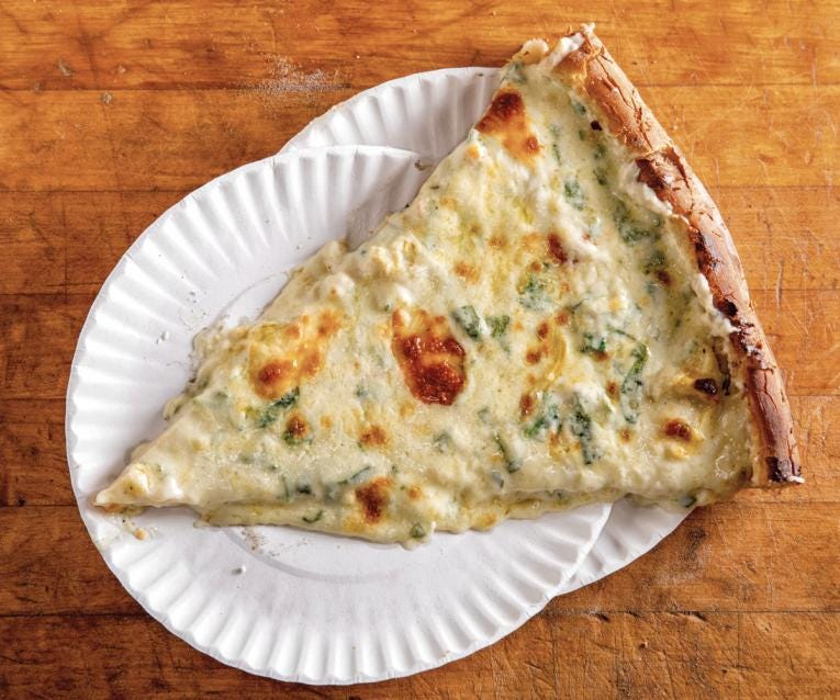 Image: A perfect slice of Artichoke pizza on two paper plates