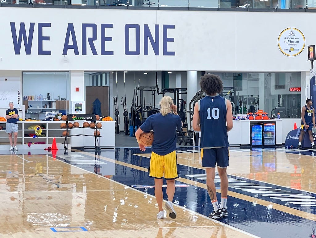 Kendall Brown, the 48th pick in the 2022 NBA Draft, works with assistant coach Jenny Boucek after practice.