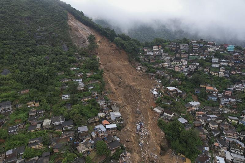 An aerial view shows neighborhood affected by landslides in Petropolis, Brazil, Wednesday, Feb. 16, 2022. Heavy rains set off mudslides and floods in a mountainous region of Rio de Janeiro state, killing multiple people, authorities reported. (AP Photo/Silvia Izquierdo)