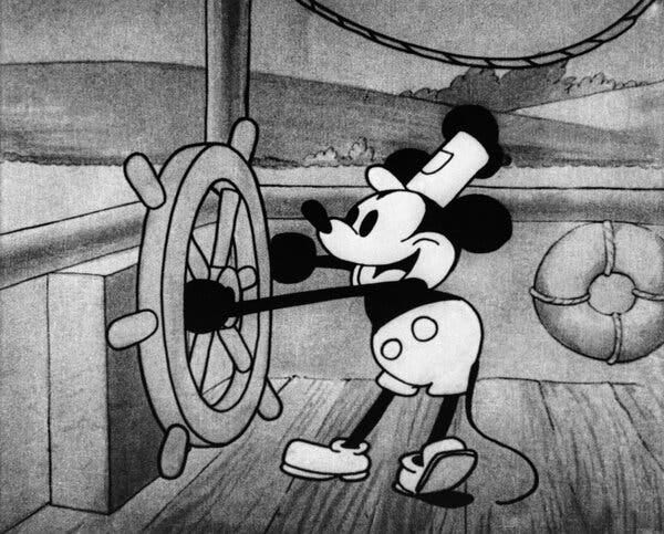 A black-and-white image of Mickey Mouse at the steering wheel of a steamboat.