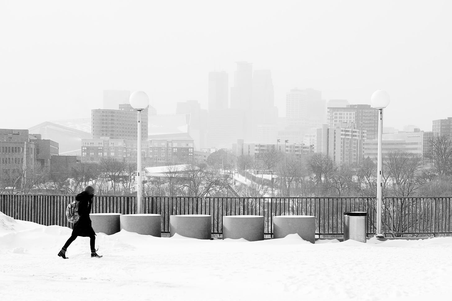 The skyline of downtown Minneapolis is obscured by snow.