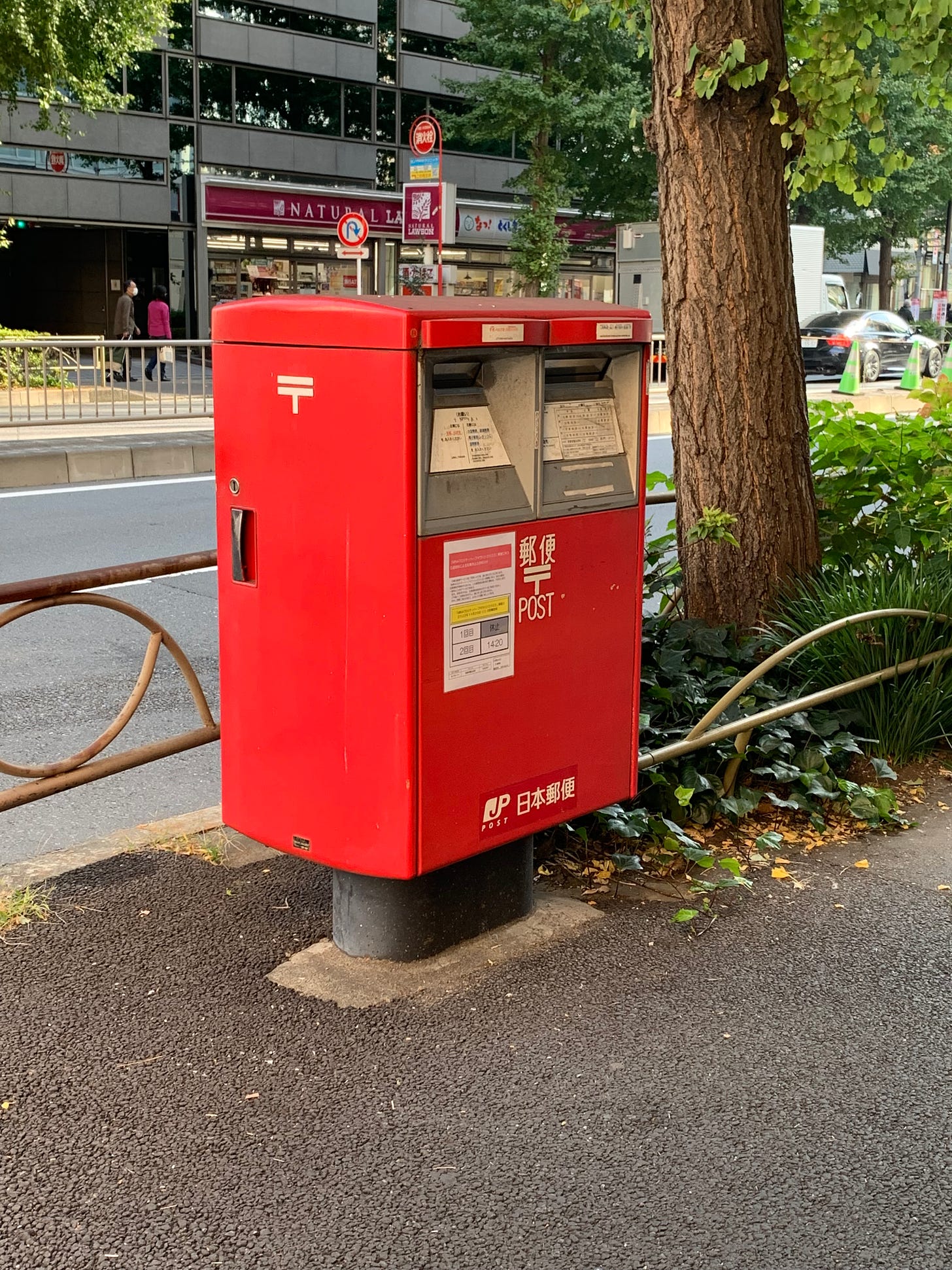Close up of red Japan Post double slotted mailbox in Tokyo.