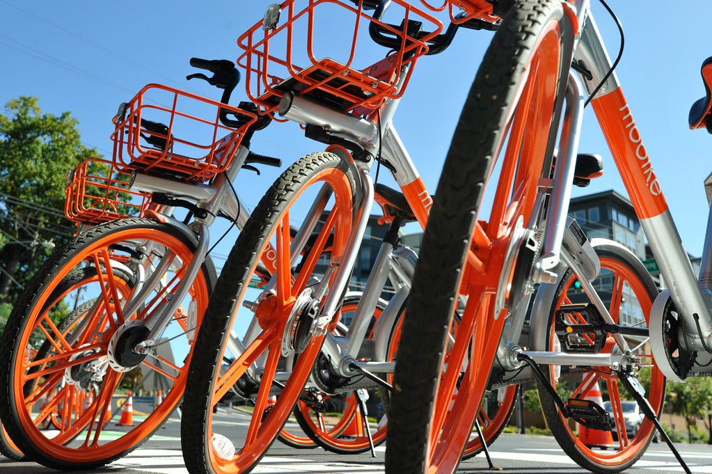 Several Mobike bikes lined up on a sunny day