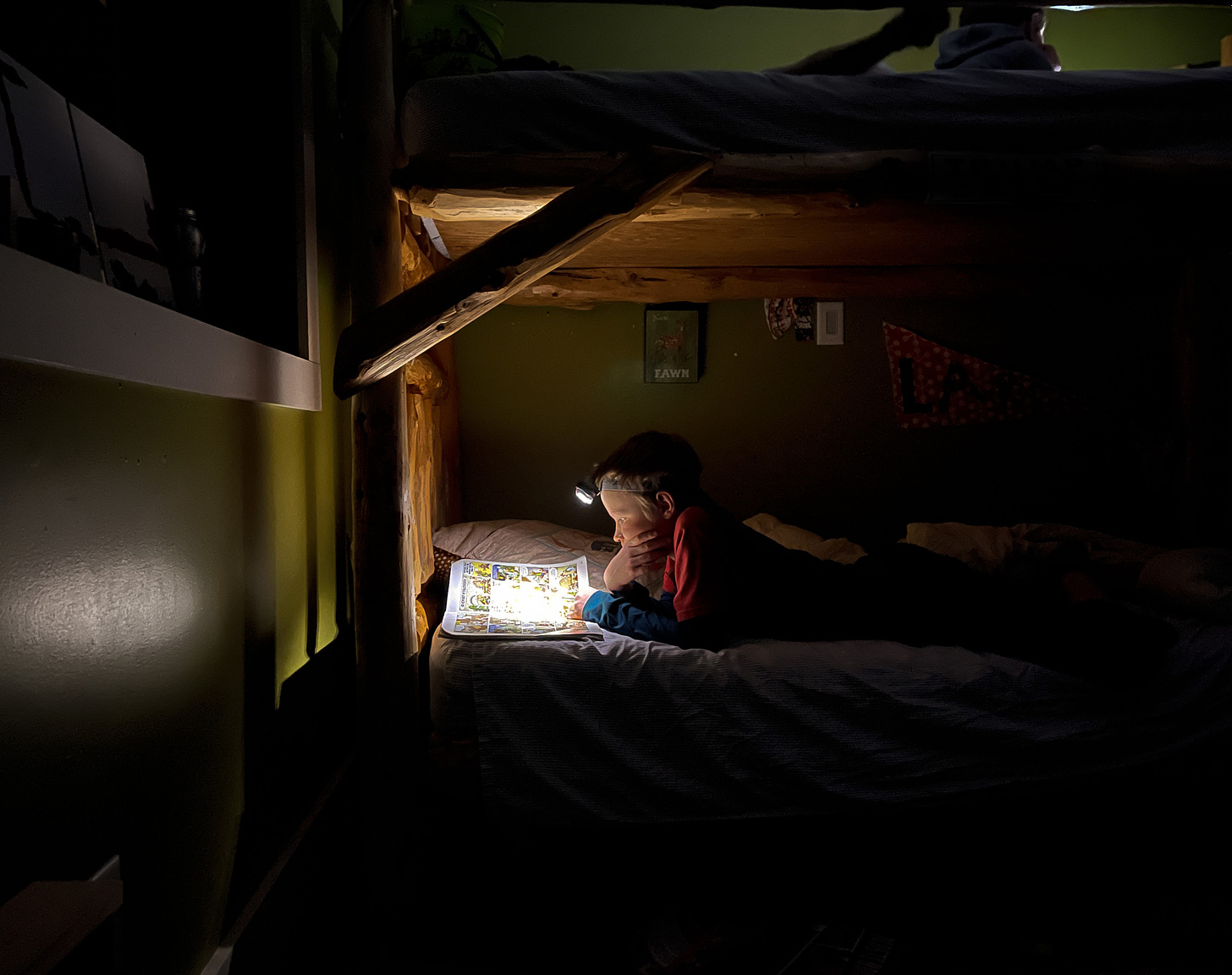 man in red shirt lying on bed photo