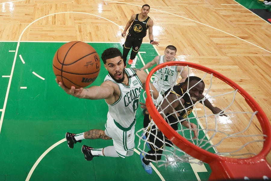 Boston Celtics forward Jayson Tatum (0) goes up for a shot against the Golden State Warriors during Game 3 of basketball's NBA Finals, Wednesday, June 8, 2022, in Boston.