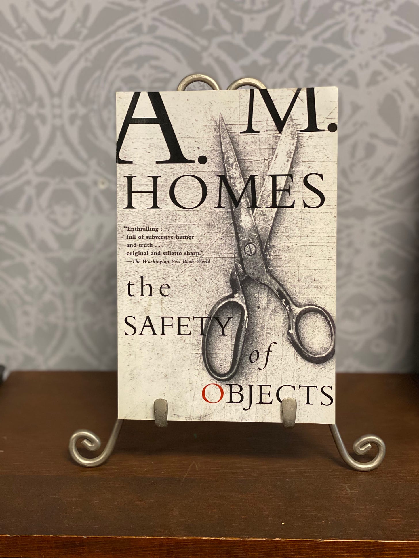 Black and white cover of The Safety of Objects, featuring an open pair of scissors and a gritty looking texture