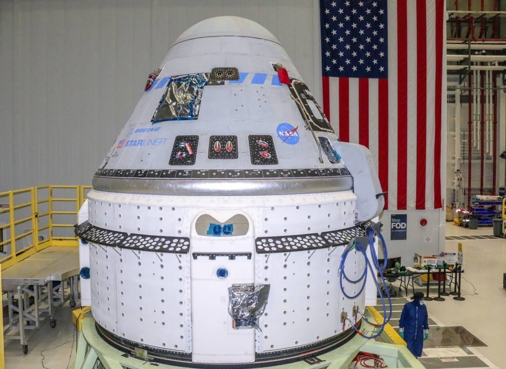 Technicians prepare Boeing’s CST-100 Starliner for the company’s Orbital Flight Test-2 (OFT-2) in the Commercial Crew and Cargo Processing Facility at NASA’s Kennedy Space Center in Florida on June 2, 2021.
