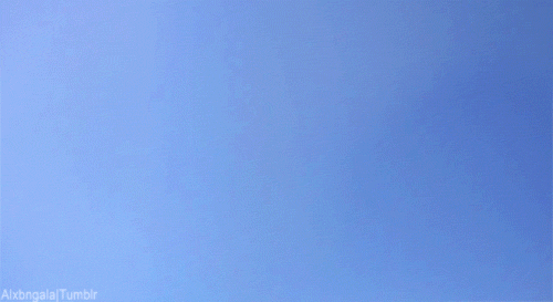 GIF of a baby blue coloured sky with a cute ginger coloured tabby kitten flying/floating past