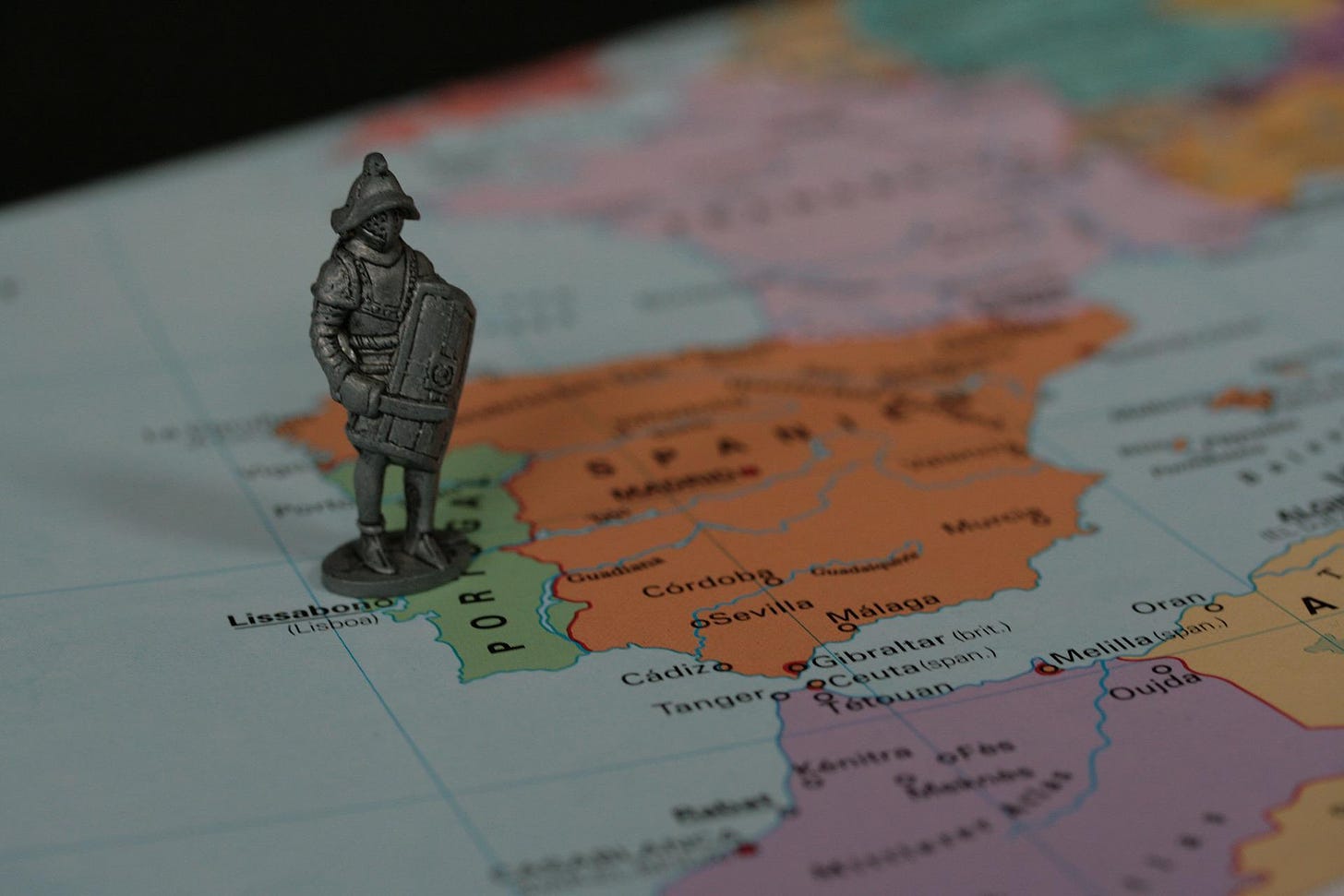 Explorer figure on top of the map of Portugal