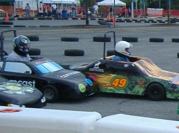 two cars in the Mini Grand Prix set to bumping and grinding through the corner.