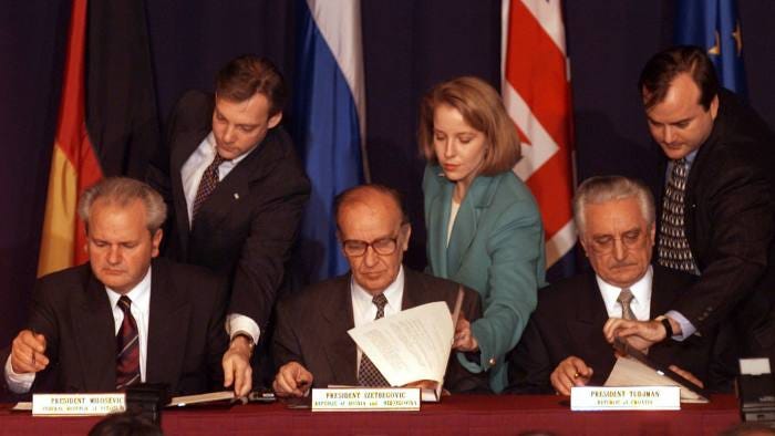 The leaders of Serbia, Bosnia and Croatia initial the peace agreement after talks in Dayton, Ohio, in 1995
