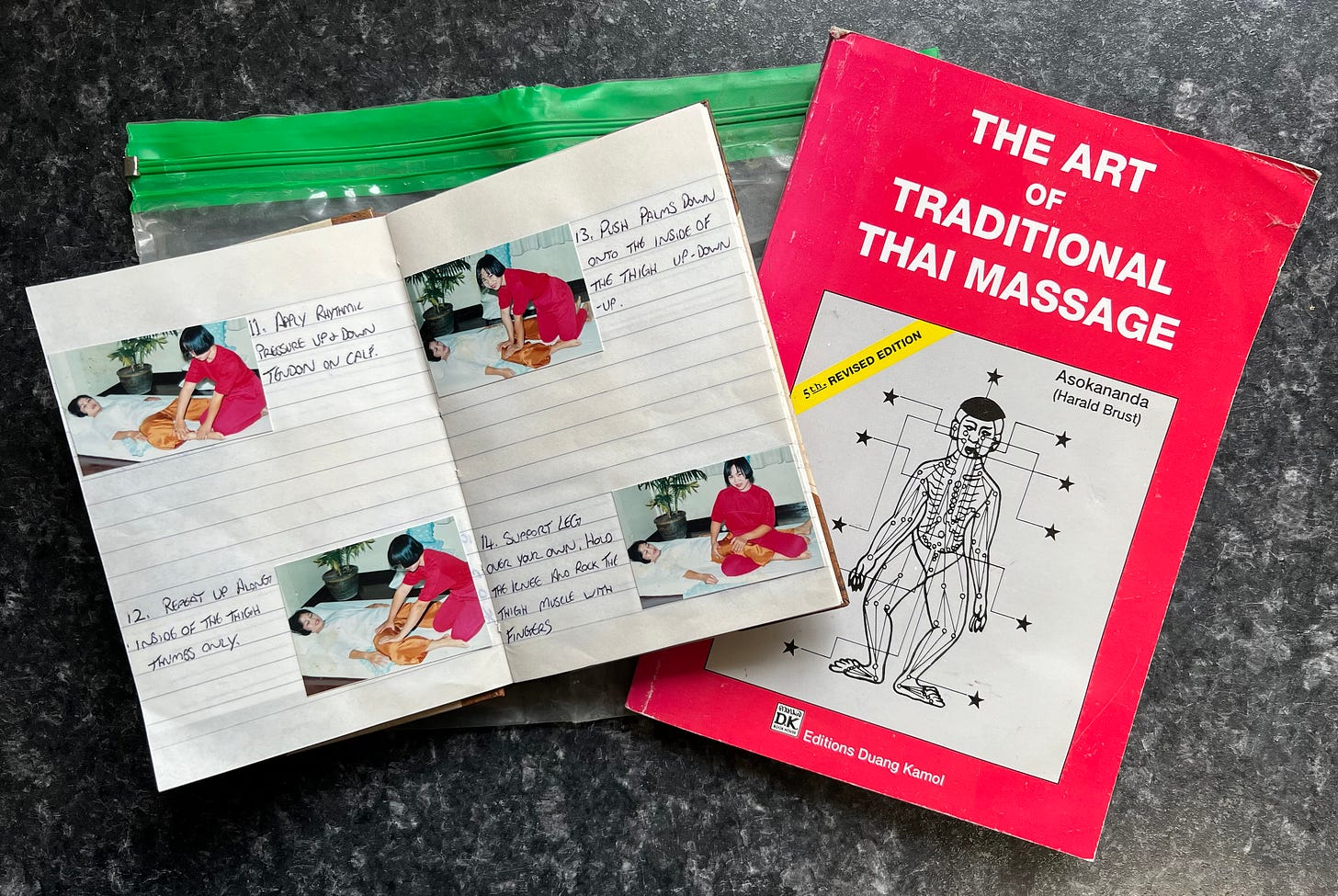 A notebook lies open showing instructions on how to massage