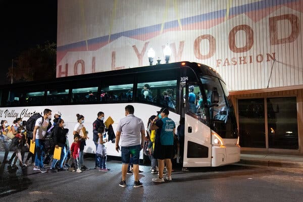 Migrant families waiting to board a charter bus in McAllen, Tex., in 2021. In recent weeks, three Republican governors have transported migrants to Democratic-leaning areas as a political stunt.