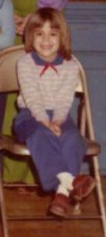 Robyn as a kindergartener, smiling widely.