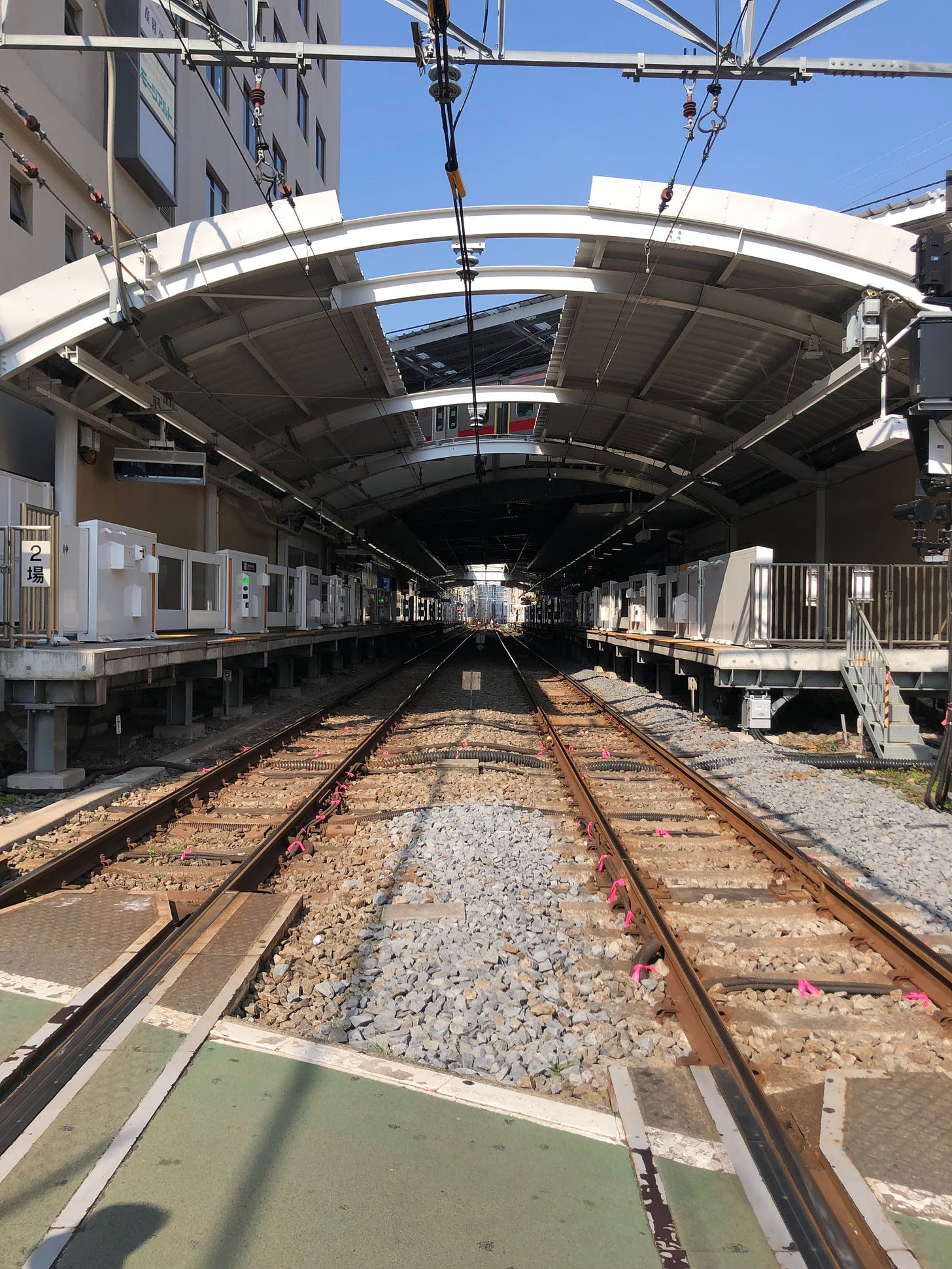 The inside of a train station and the train tracks leading in