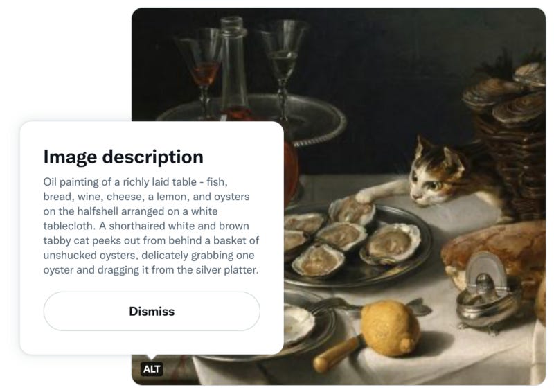 A tweet with a painting of cats at a dinner table. The image description is shown, and reads: “Oil painting of a richly laid table — fish, bread, wine, cheese, a lemon, and oysters on the halfshell arranged on a white tablecloth. A shorthaired white and brown tabby cat peeks out from behind a basket of unshucked oysters, delicately grabbing one oyster and dragging it from the silver platter.”