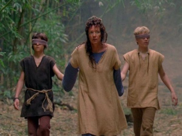 Mother (Alison Janney) leads blindfolded Brother and Jacob by the hand.