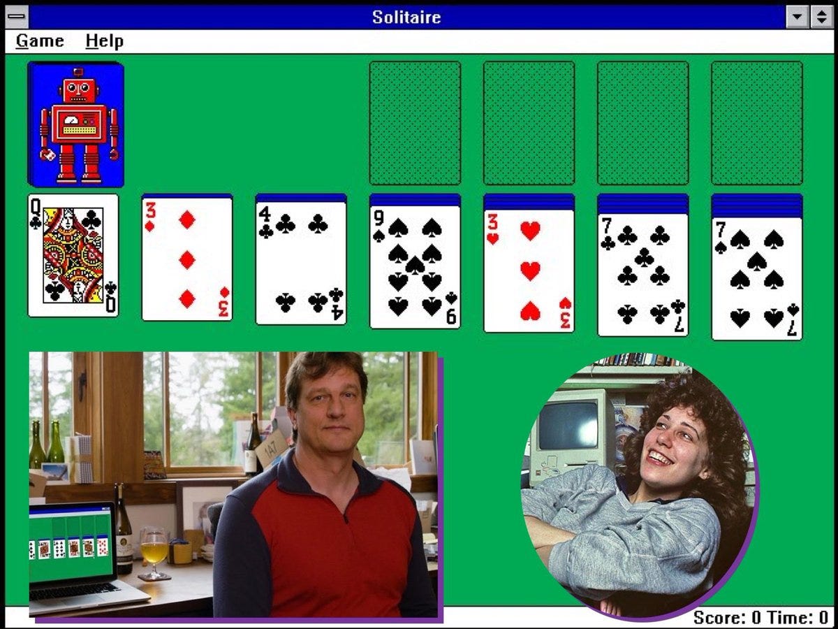A screenshot of Microsoft Solitaire with photographs of Wes Cherry and Susan Kare superimposed