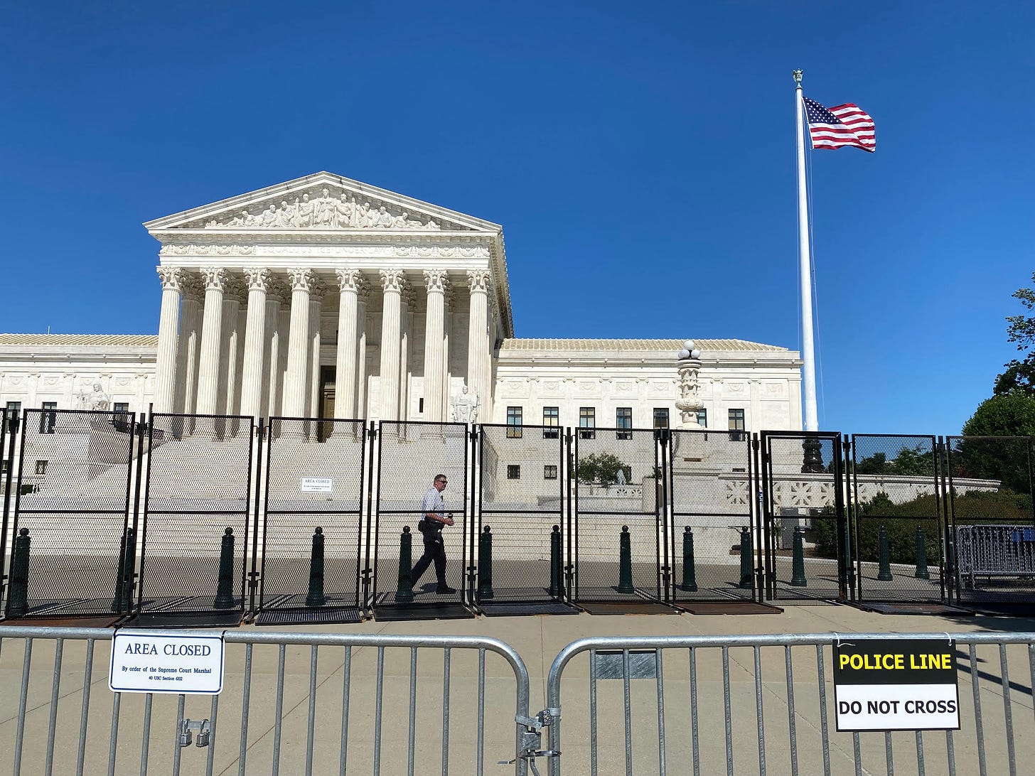 The Supreme Court building, behind two rows of fences.
