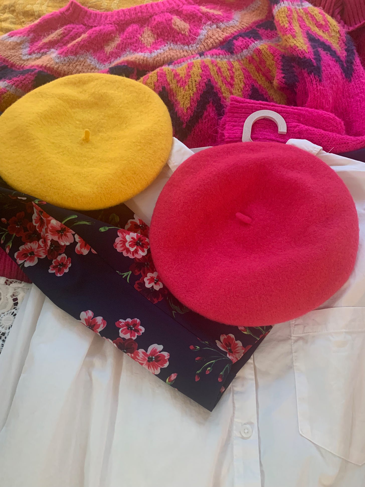 A mustard beret and a raspberry beret