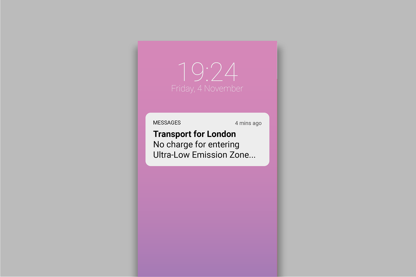 Text messaged on phone screen reading 'Transport for London. No charge for entering Ultra-Low Emission Zone'