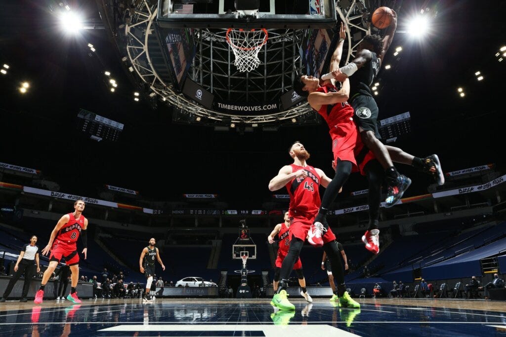 Anthony Edwards of Minnesota dunks on Toronto's Yuta Wantanabe of Toronto during the Raptors' win over the Timberwolves.
