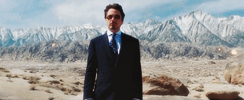 Tony Stark gif with his own weapons blowing up behind him