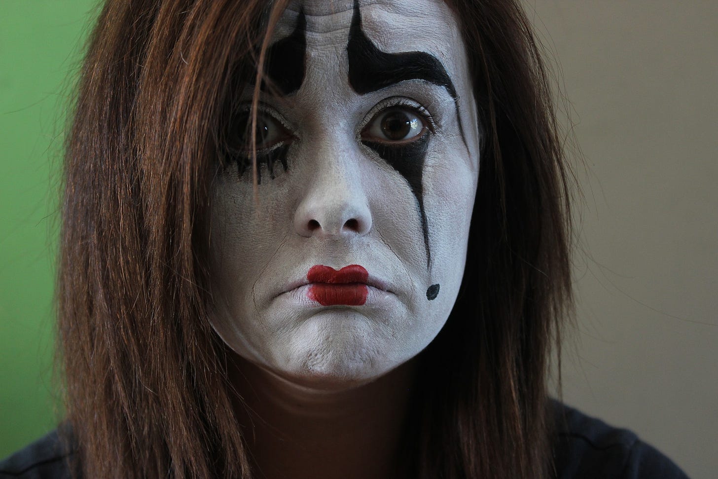 a sad looking female mime artist